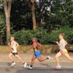 Three runners in mid-race down 5th Avenue in New York City